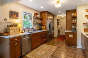 "Custom-built wooden kitchen cabinets and wall shelves for a warm atmosphere."