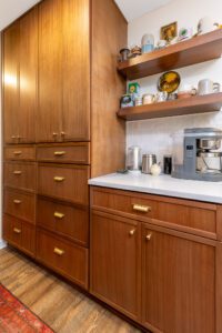 "Custom kitchen remodel with brown cabinets and wall-mounted shelving units."