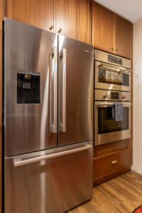 "Stylish brown cabinets with modern handles in a remodeled kitchen."