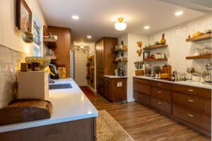 "Modern kitchen design with brown-toned cabinets and custom shelving."