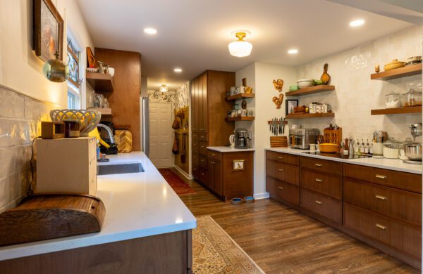 "Modern kitchen design with brown-toned cabinets and custom shelving."