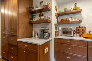 "Modern kitchen solution featuring brown cabinets and stylish handles."